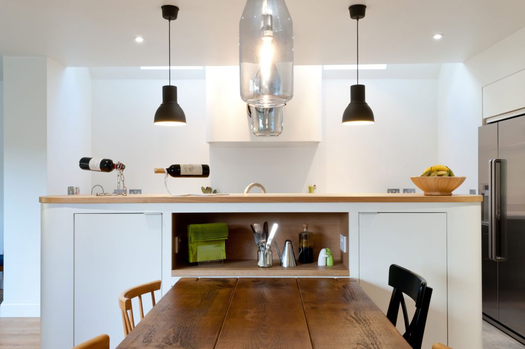 A white plywood kitchen with wooden worktop and accents - a bespoke kitchen built from scratch by the Koivu team. 