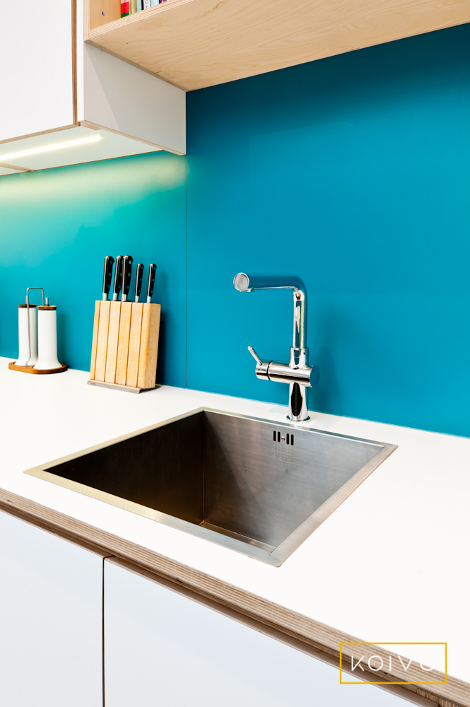 Tap situated against turquoise blue wall - Koivu Kitchens. Be mindful of how much you're running the tap. 