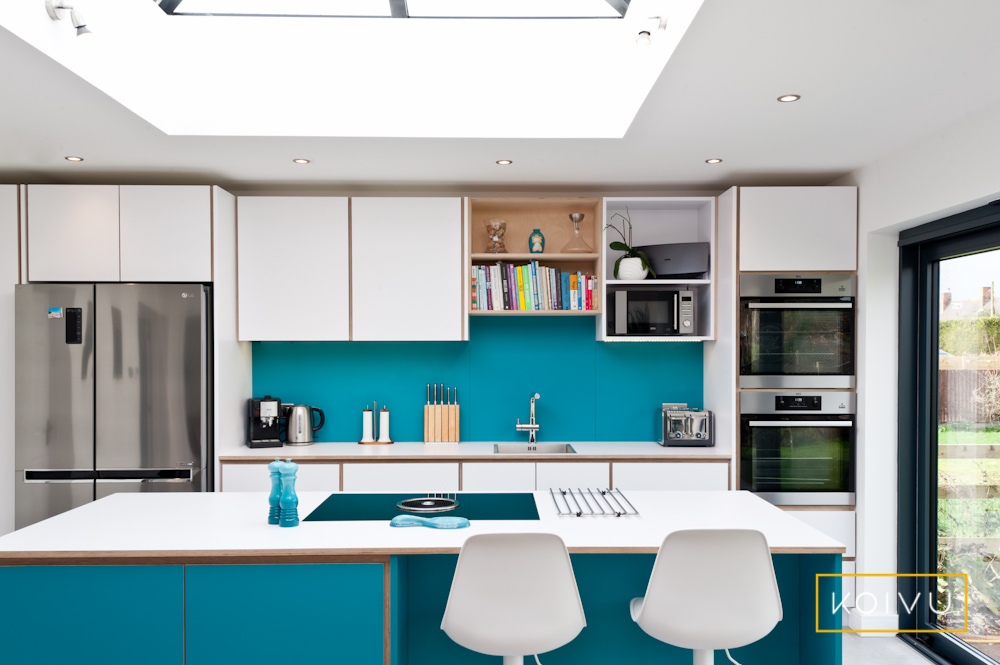 Turquoise kitchen with white countertops. This was a small kitchen design by Koivu.