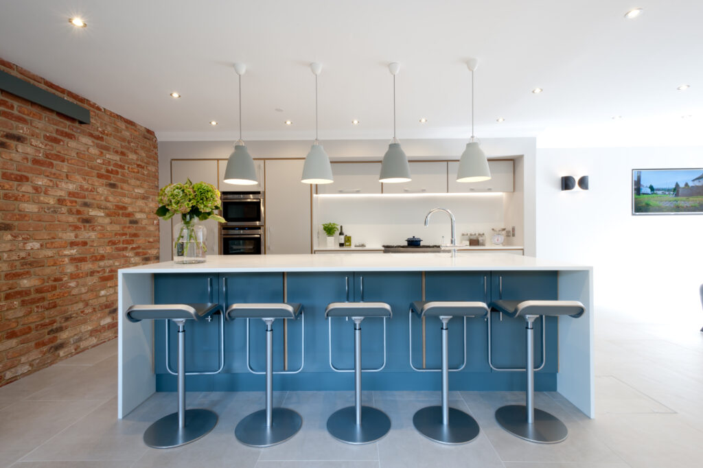 Plywood kitchen in blue and white with brick wall