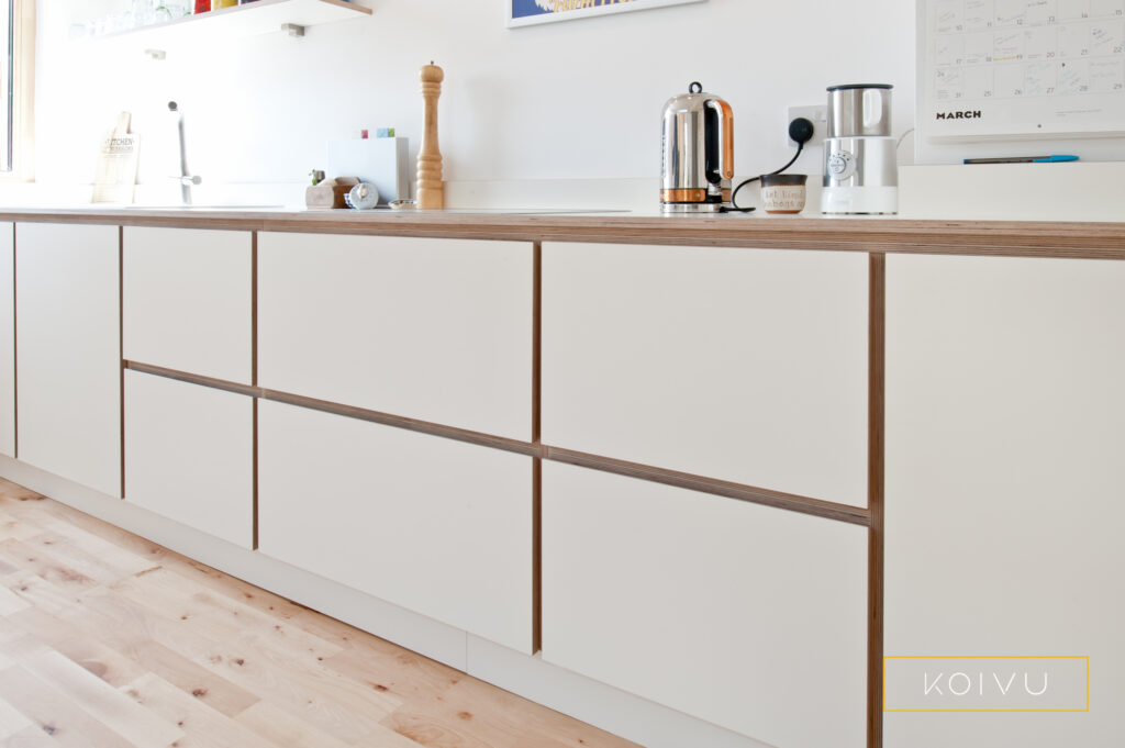 White drawers with plywood detailing in a Canterbury kitchen designed by Koivu.