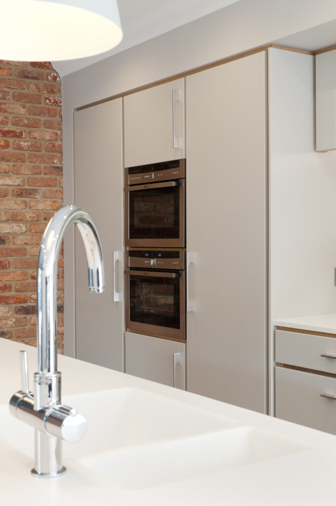 Plywood kitchen sink in island, oven housing and fridges