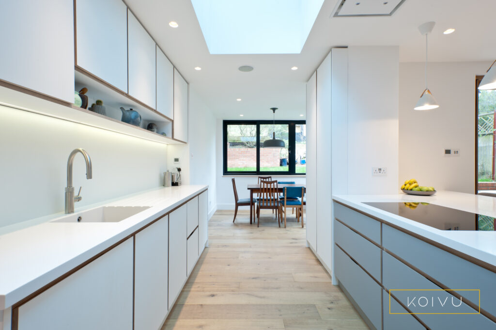 Plywood kitchen in white and grey view of units towards dining area