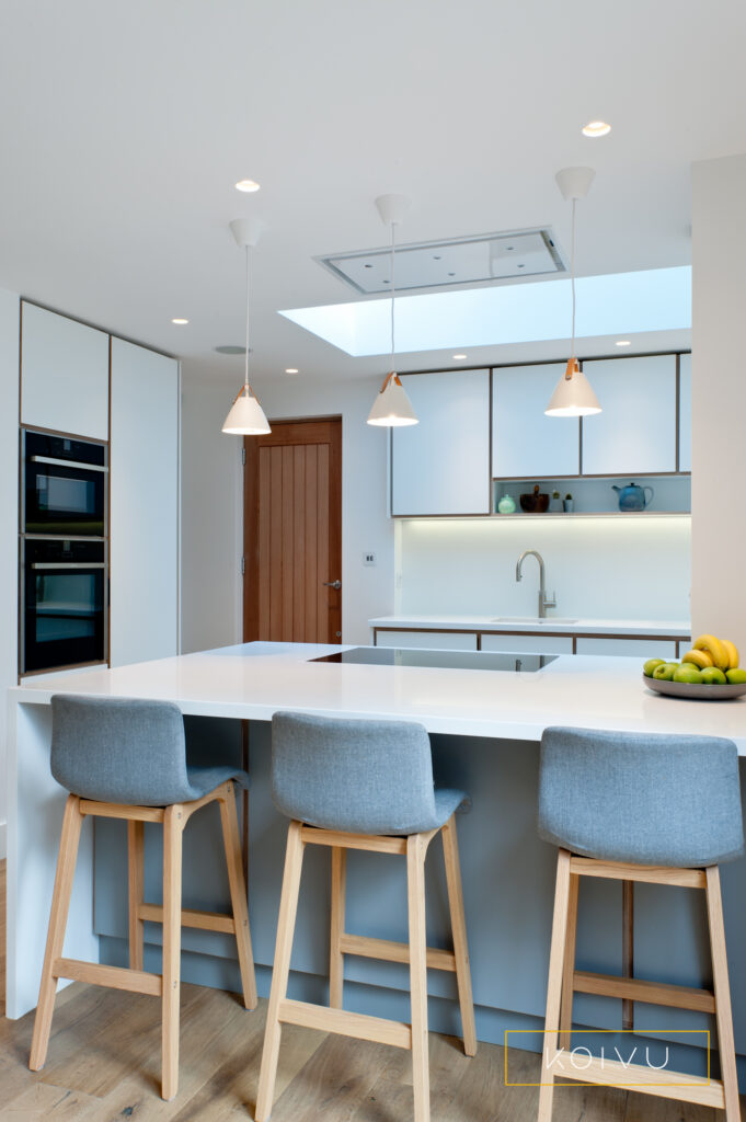 White and grey plywood kitchen with tall oven housing