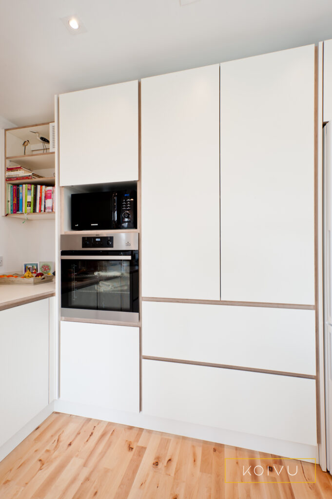 White plywood kitchen larder with deep drawers and oven housing. Designed by Koivu