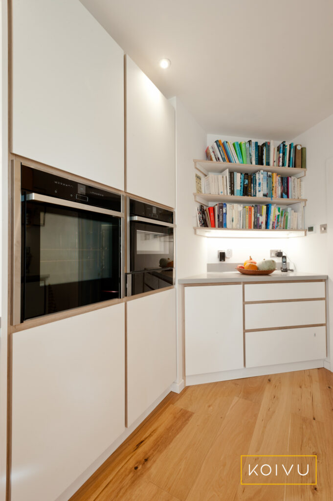 Kitchen with open shelving and bespoke units to maximise storage space. By Koivu.