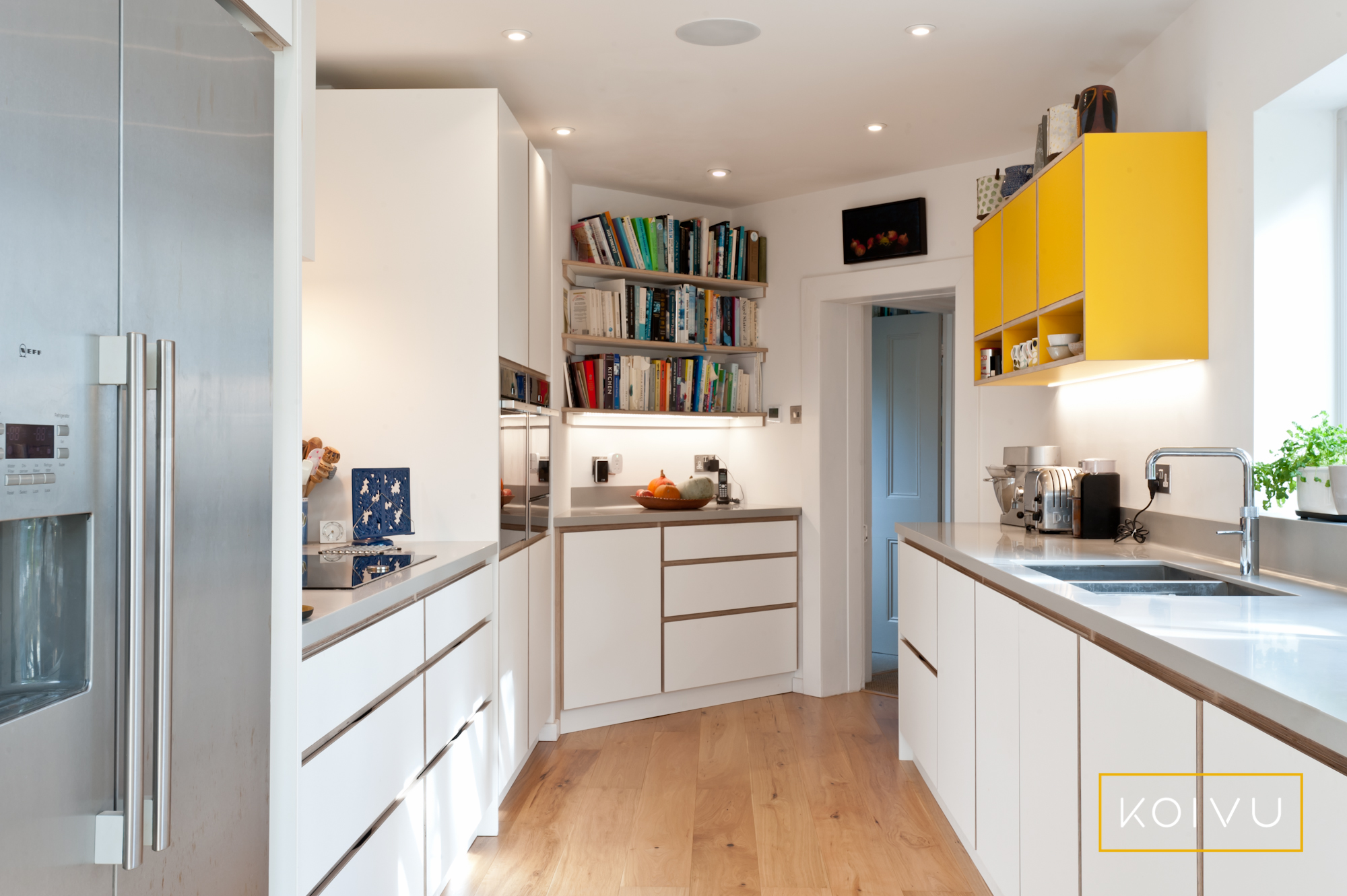 Bespoke designed plywood kitchen with white and yellow units. Designed by Koivu.