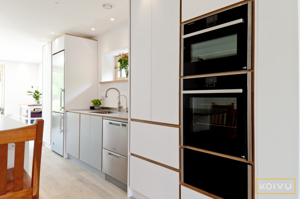 Oven housing at one end of the kitchen run and larder at the other