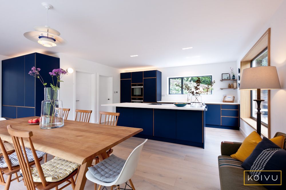 Open plan kitchen layout with dark blue colour scheme