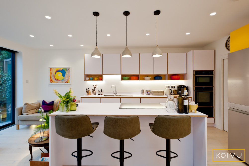 white plywood kitchen with yellow accents. By Koivu.