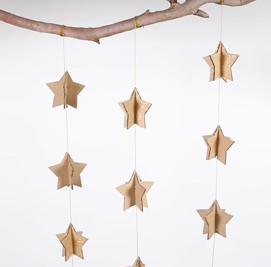 Cut out cardboard stars and string them up for this lovely Christmas decoration